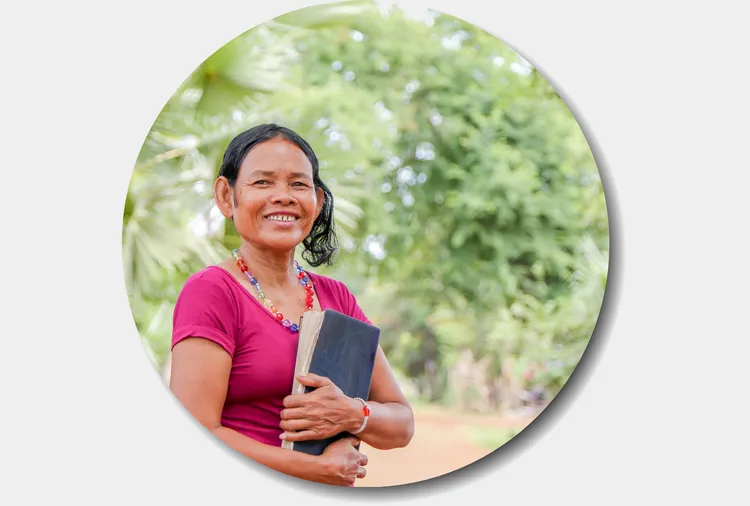 Smiling lady clutching a Bible
