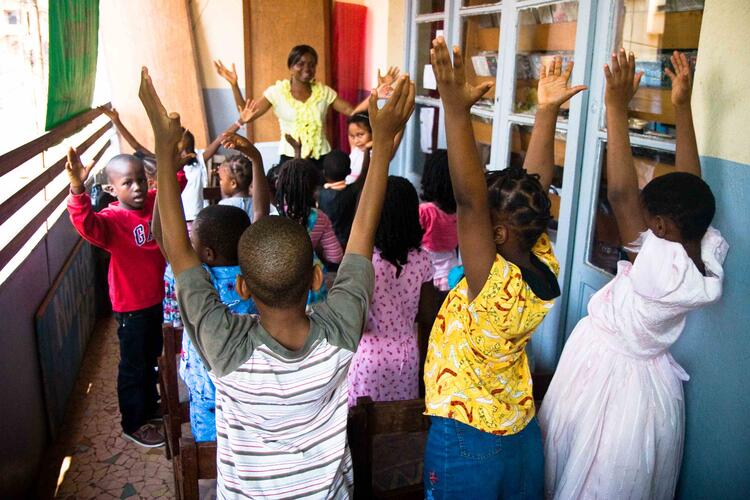 cameroon, kids in circle with teacher