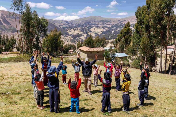 children in circle with mountainous background