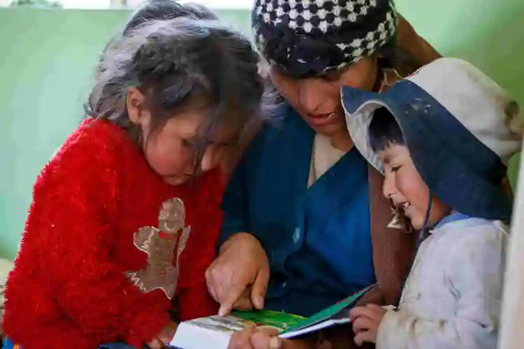 South American mom with 2 kids reading, Marc Ewell