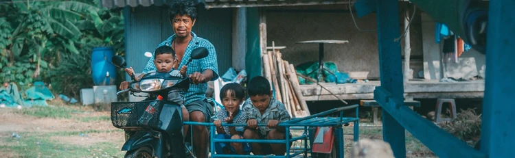 Man with children on motorbike