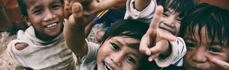 group of boys smiling and pointing at camera